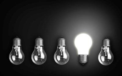 Idea concept with row of light bulbs, one of them is glowing.